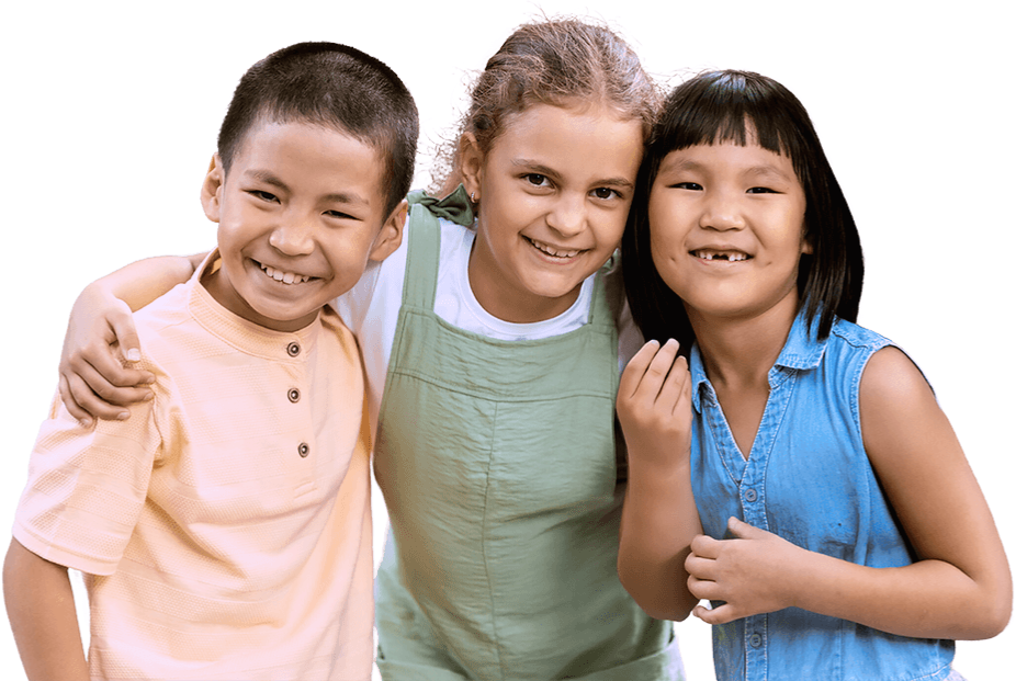 Three children are joyfully smiling while holding hands together in a display of friendship and happiness.