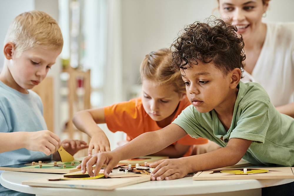 Children engaged in play-based learning, assembling wooden puzzles in a bright classroom setting.